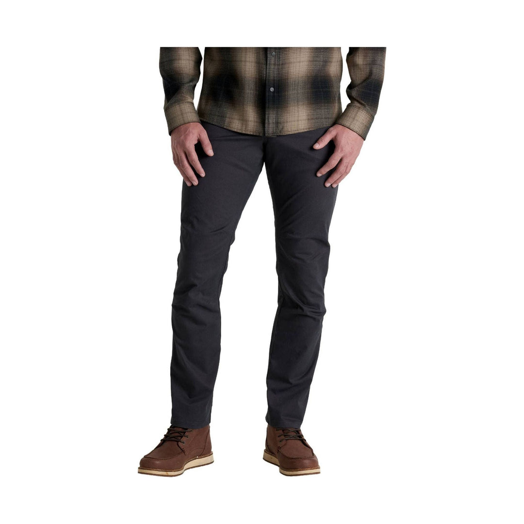 Dark straight-leg pants with a plaid button-up shirt and brown lace-up boots
