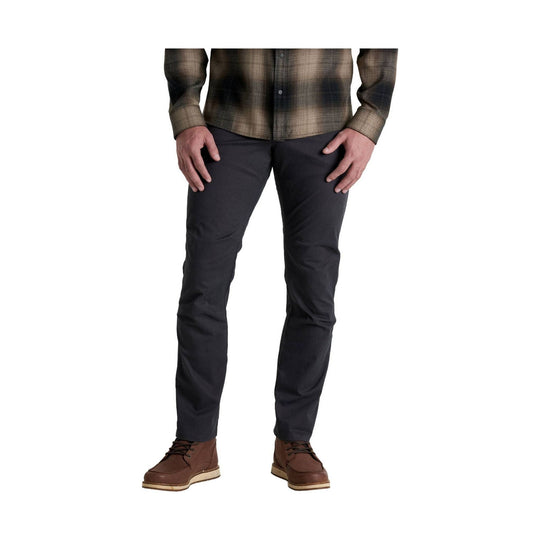 Dark straight-leg pants with a plaid button-up shirt and brown lace-up boots