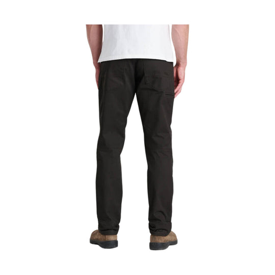 Person wearing brown pants on a white background