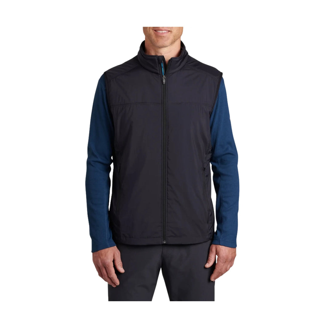 Black zip-front vest worn over a blue long-sleeve shirt on a model against a white background