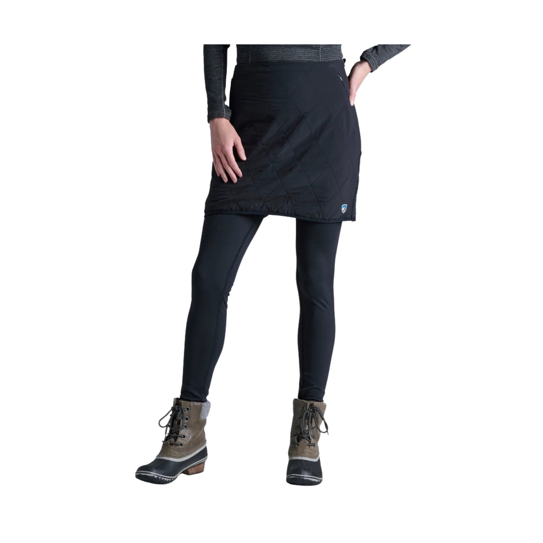 Black quilted athletic skirt over black leggings with lace-up boots