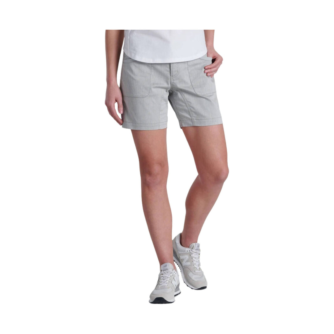 Light gray women's shorts with front patch pockets, shown with a white top and white sneakers