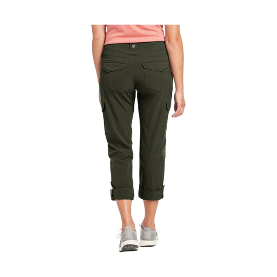 Olive green cropped cargo pants shown from the back with rolled cuffs and flap pockets