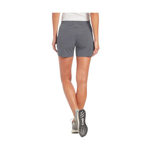 Gray athletic shorts shown from the back on a model wearing running shoes