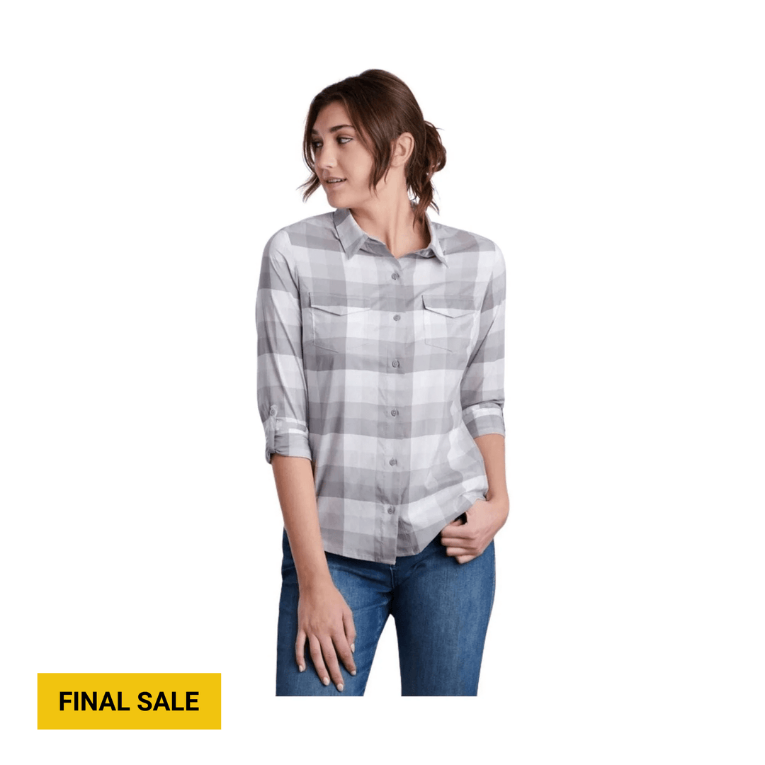 Woman wearing a gray plaid long-sleeve button-up shirt with chest pockets