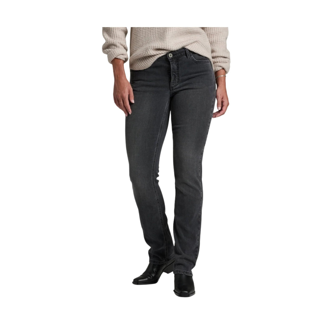 Dark straight-leg jeans with a high rise, shown on a model with black ankle boots.