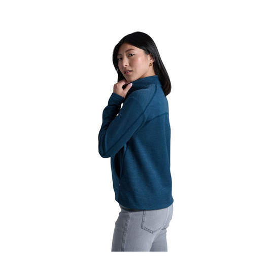 Teal long-sleeve half-zip top shown in side profile with a high collar and seam details
