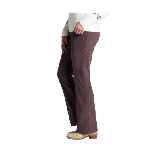 Brown corduroy straight-leg pants on a model, shown from the side with beige clogs