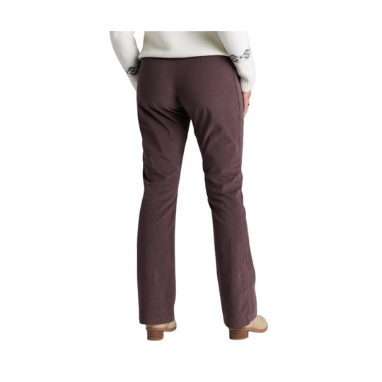 Brown straight-leg pants shown from the back on a model with beige shoes