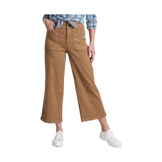 Tan wide-leg cropped pants with front patch pockets, shown with a tied plaid shirt and white sneakers