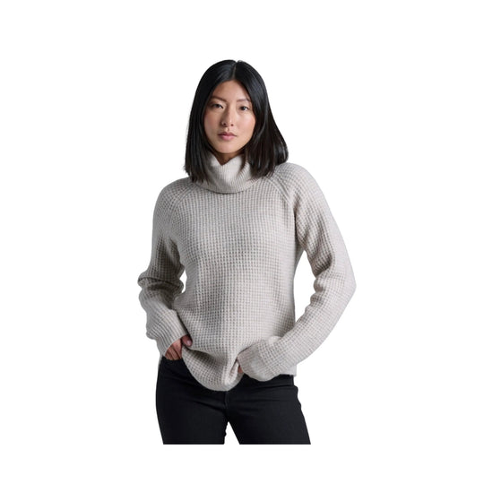 Light gray textured turtleneck sweater worn with black pants