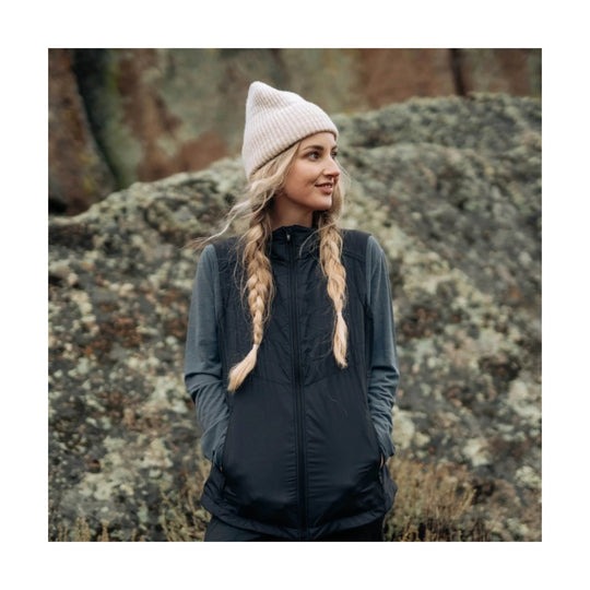 Black zip-front quilted vest worn over a long-sleeve top