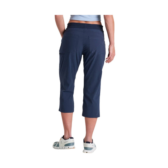 Navy cropped pull-on hiking pants shown from the back with a wide waistband and rear pockets