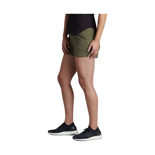 Olive green athletic shorts with a 4-inch inseam, shown on a model with black running shoes