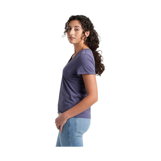 Purple short-sleeve T-shirt shown in side profile with light-wash jeans