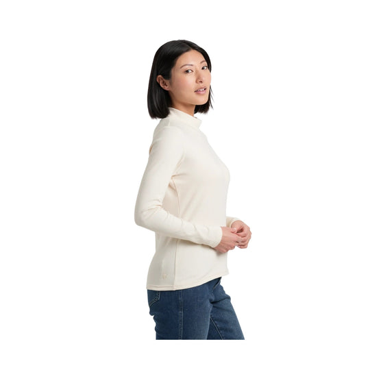 Cream ribbed long-sleeve mock neck shirt with a fitted silhouette, shown in side view with blue jeans