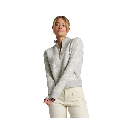 Light gray quarter-zip sweater with subtle floral pattern, long sleeves, and cream pants