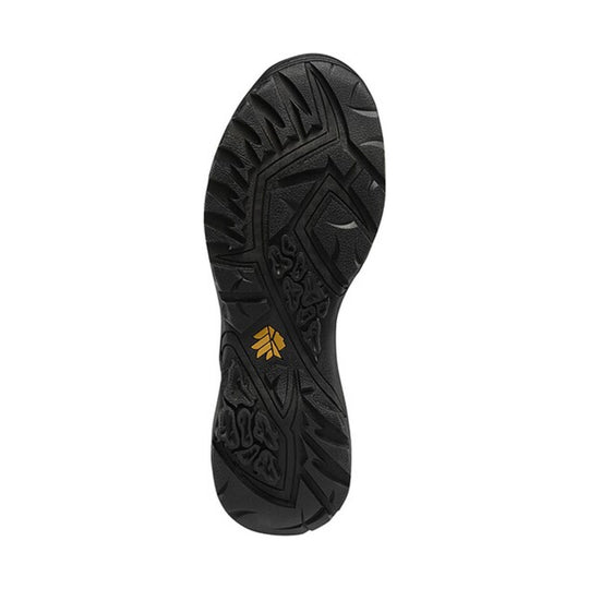 Black boot outsole with deep traction lugs and a small gold logo near the center