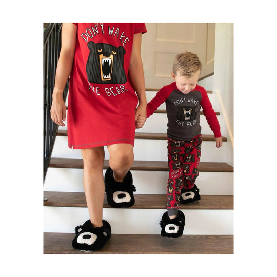 Bear-face slippers worn with matching bear pajamas on a parent and child