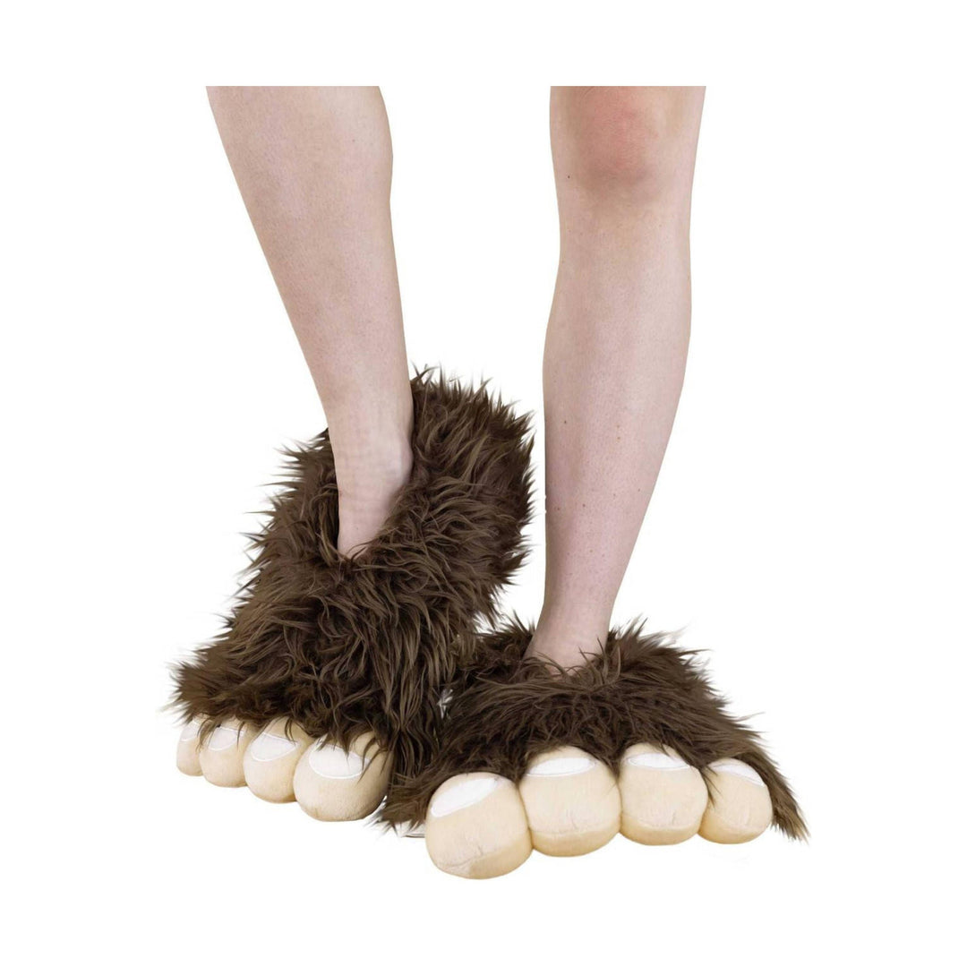 Brown shaggy faux-fur slippers with paw-shaped toes and oversized toe pads on bare legs