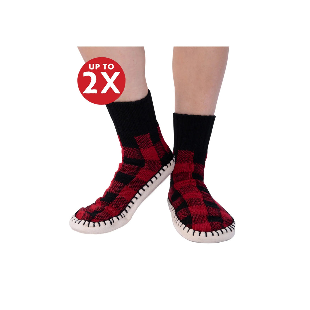 Red and black plaid knit slipper socks with white soles and black whipstitch trim, shown on legs with a "UP TO 2X" badge