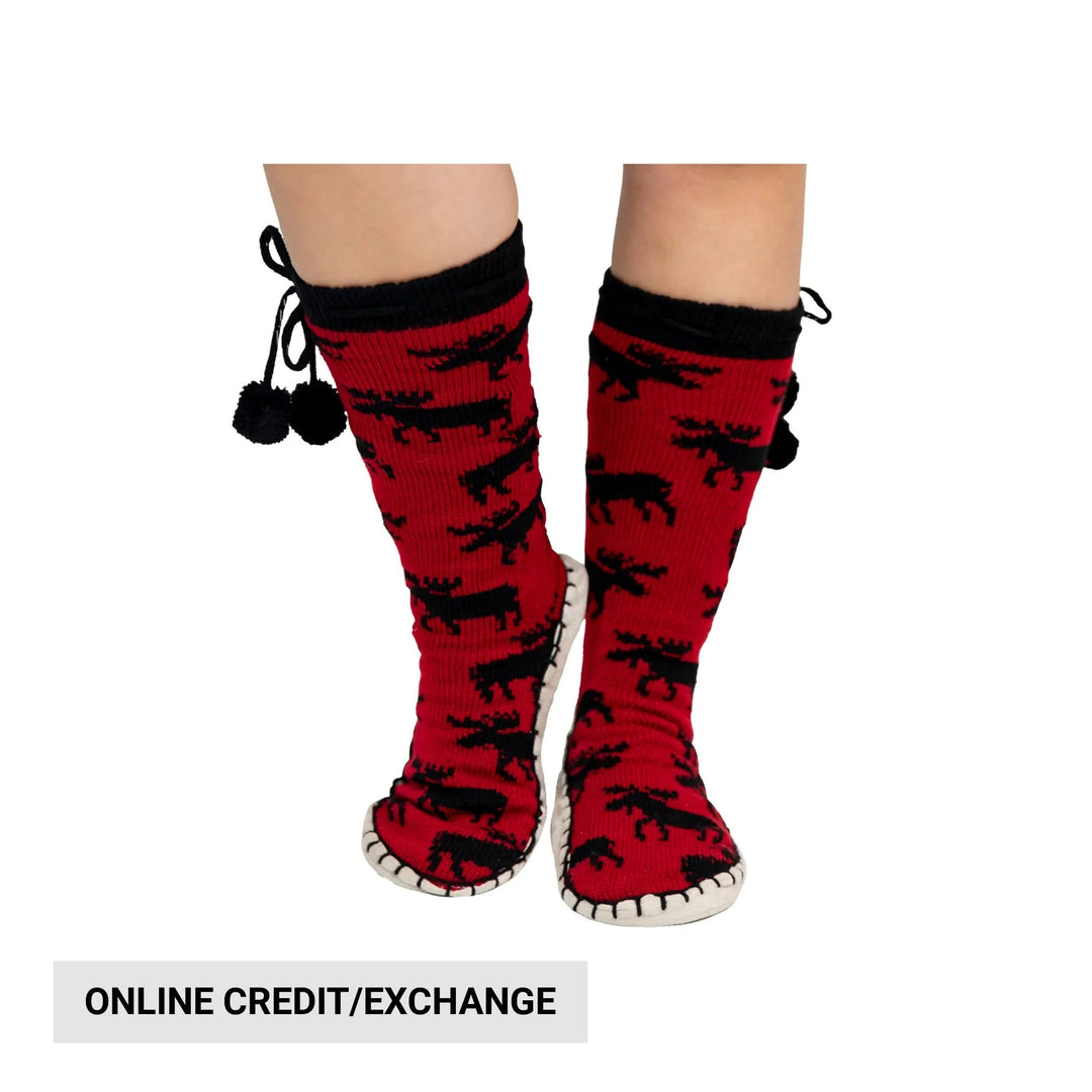 Red knit slipper boots with black pattern, white stitched soles, and pom-pom ties, shown on legs