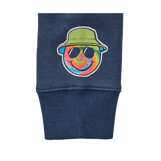 Navy fleece sleeve with a tie-dye smiley face patch wearing a green bucket hat and sunglasses