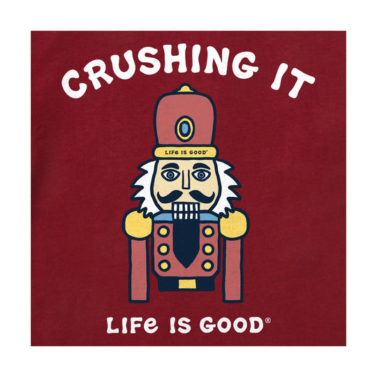 Red graphic T-shirt with a nutcracker illustration and the words “Crushing It”