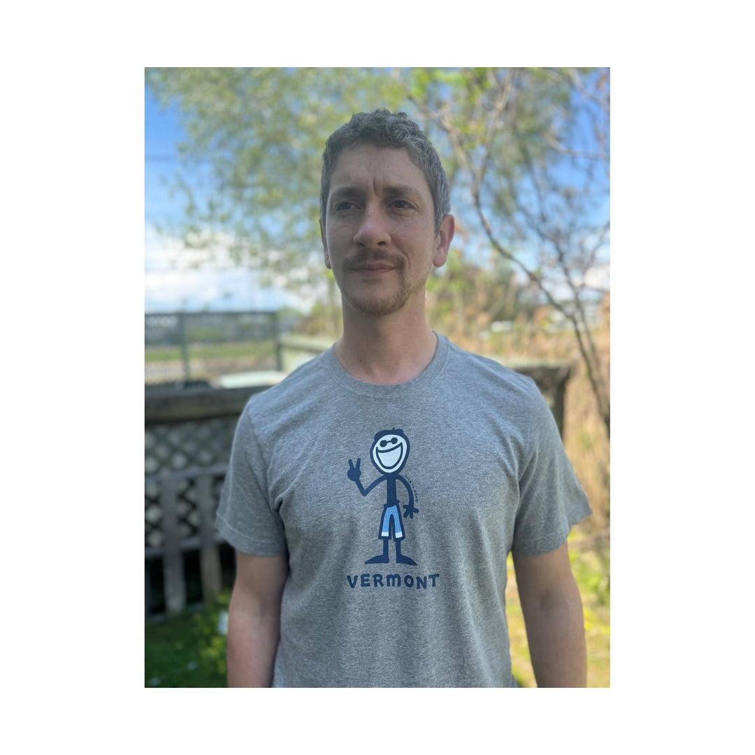 Gray short-sleeve T-shirt with a blue cartoon figure and the word “VERMONT” on the chest