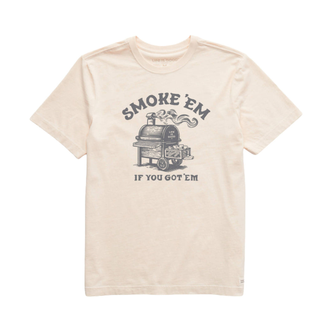Cream short-sleeve T-shirt with a smoky grill graphic and arched text reading “SMOKE ’EM”