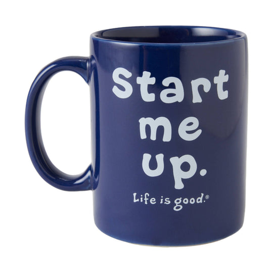 Dark blue mug with handle and white text reading “Start me up.”