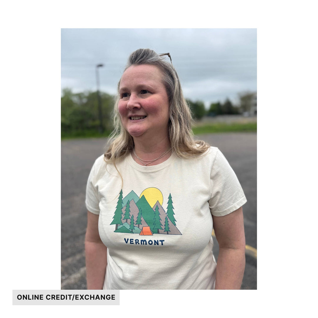 Cream T-shirt with a mountain, trees, and sunset graphic, with VERMONT text
