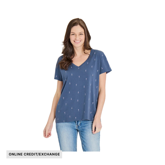 Blue V-neck short-sleeve T-shirt with tiny wine glass pattern, shown on a model with jeans