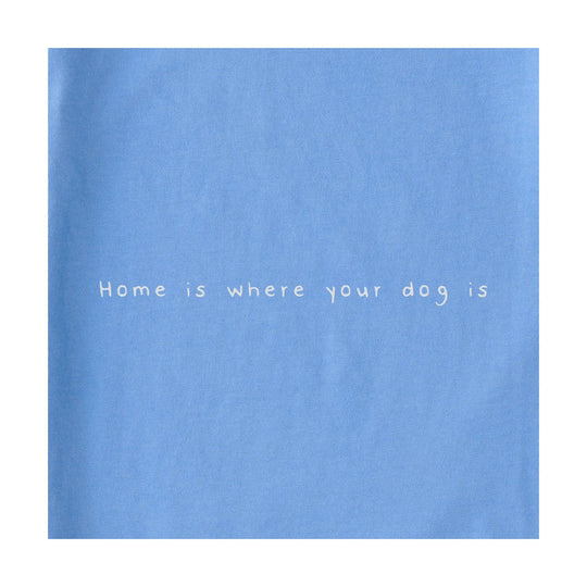 Light blue shirt with the phrase “Home is where your dog is” printed on the front