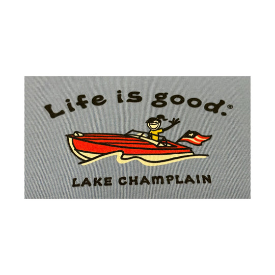 Gray T-shirt graphic with a red boat and the text "Life is good." and "LAKE CHAMPLAIN"