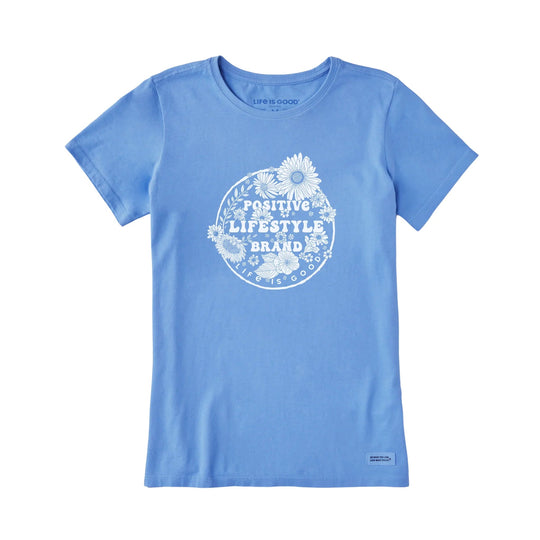 Light blue short-sleeve T-shirt with a white floral circle graphic and positive lifestyle text.