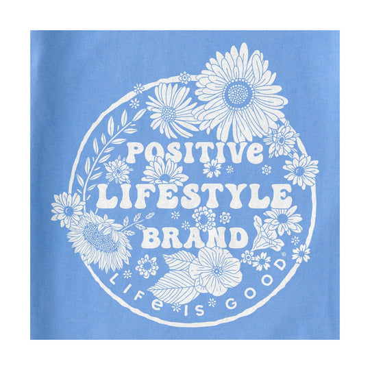 Blue graphic T-shirt with a white floral circle and the words “Positive Lifestyle Brand”