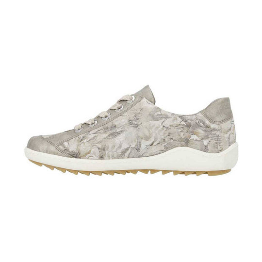 Beige low-top sneaker with floral print, white sole, and tan tread