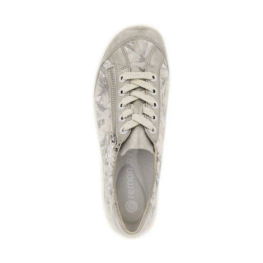 Beige low-top sneaker with woven laces, side zipper, and floral pattern