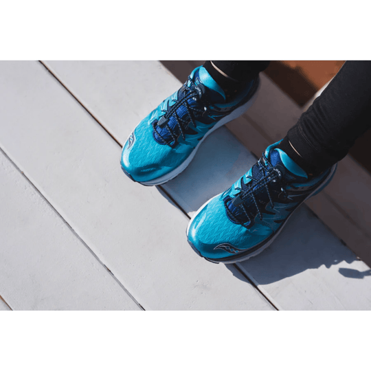 Blue elastic no-tie shoelaces on teal running shoes