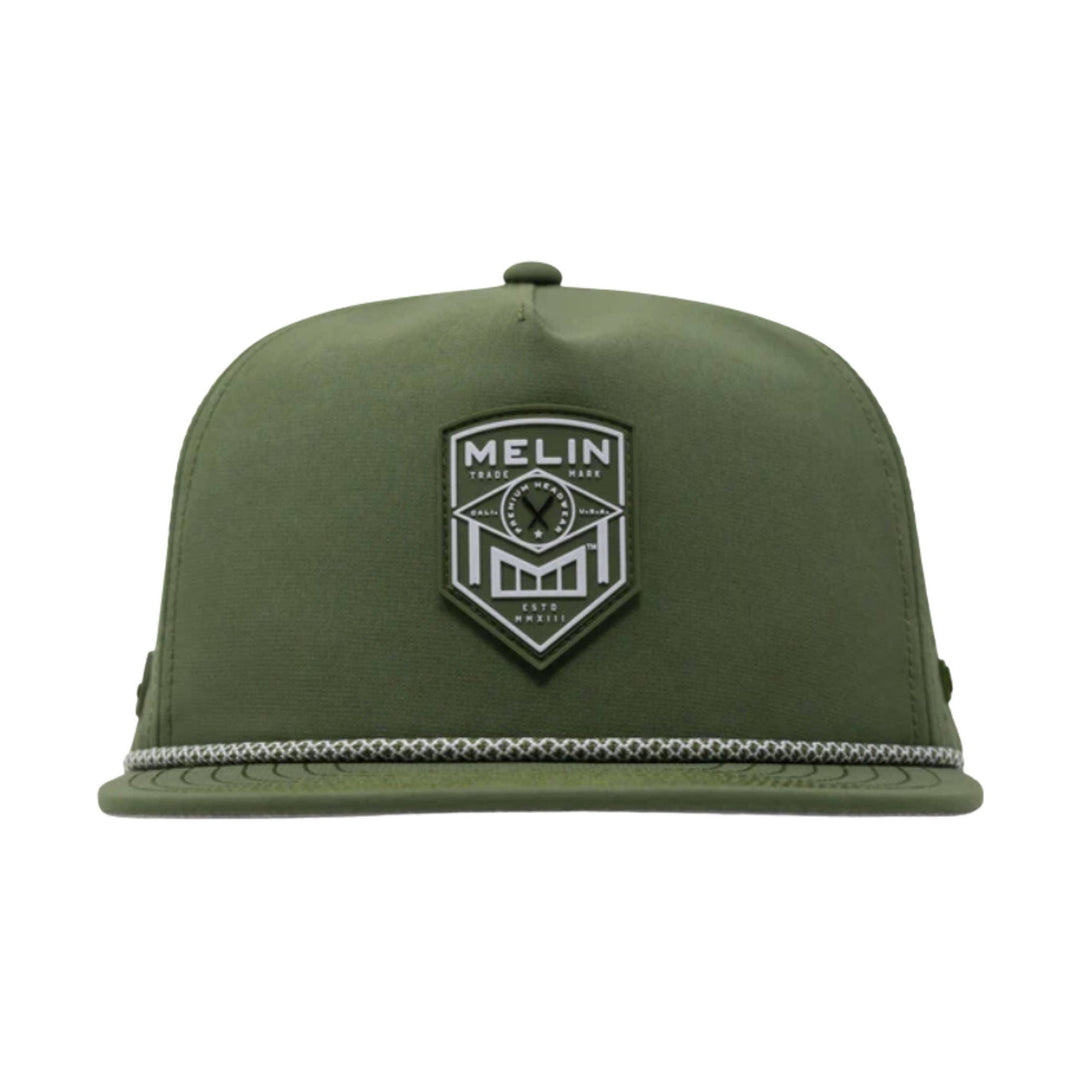 Olive green flat-brim cap with a front shield patch and braided rope across the brim