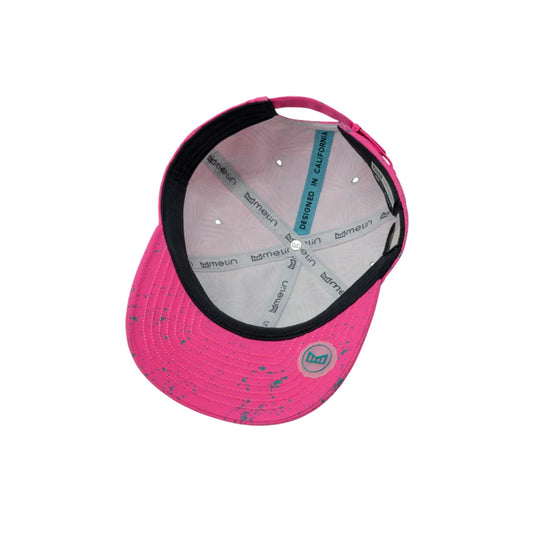 Hot pink baseball cap with black brim lining, teal speckled accents, and "DESIGNED IN CALIFORNIA" on the underside