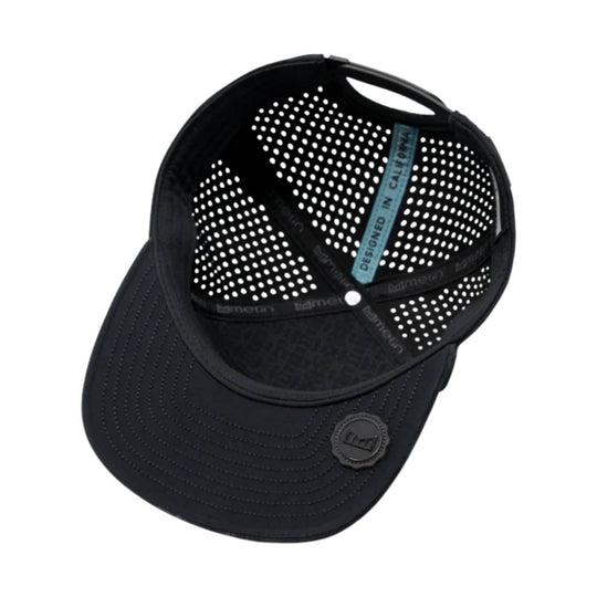 Black perforated trucker cap shown upside down with a teal "DESIGNED IN CALIFORNIA" tag