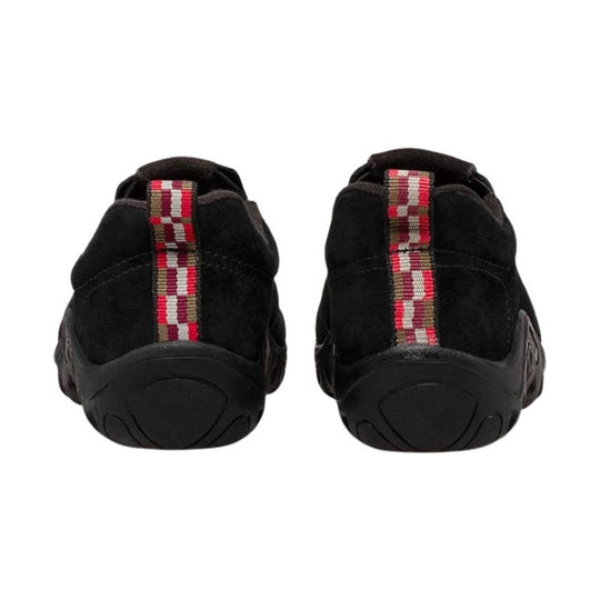 Black slip-on shoes with red and tan woven heel tabs, rear view