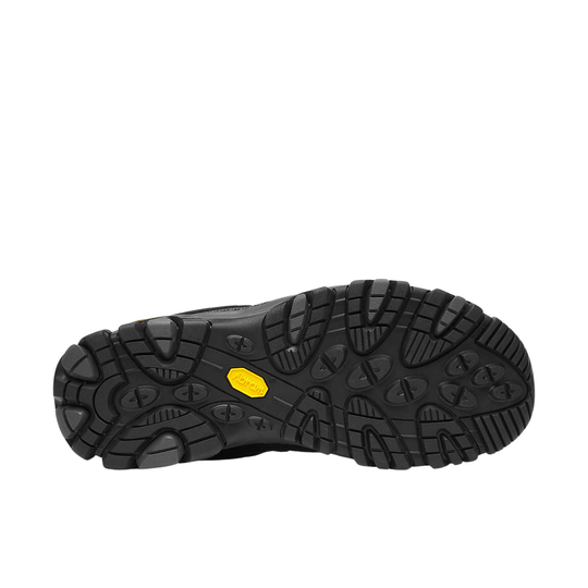 Black hiking shoe outsole with deep lug tread and yellow Vibram badge