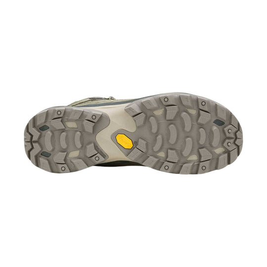 Gray hiking boot outsole with deep lugged tread and yellow Vibram badge