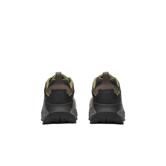 Rear view of a pair of dark brown and black hiking shoes with olive accents and lugged soles
