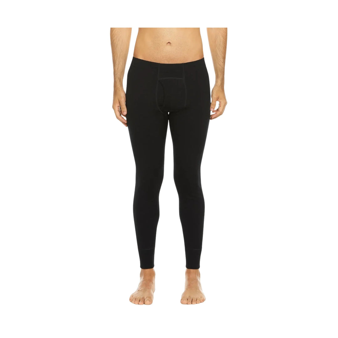Black thermal base-layer leggings with a front pouch and fitted ankle cuffs, shown on a model