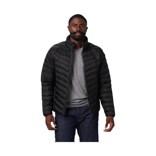 Black quilted zip-front puffer jacket worn over a gray T-shirt with dark jeans