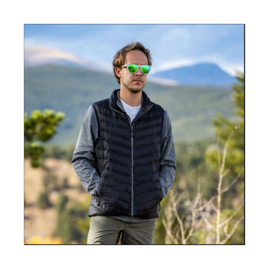 Black quilted heated vest worn over a gray long-sleeve shirt